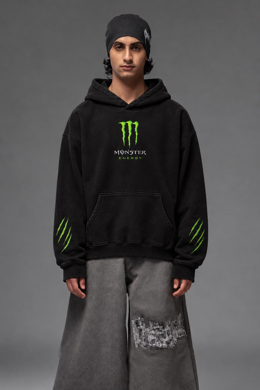 AMARCO MONSTER black oversized hoodie front close-up on model with green chest print and sleeve graphics