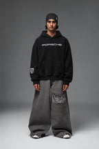 Full-length front view of the black Porsche oversized hoodie