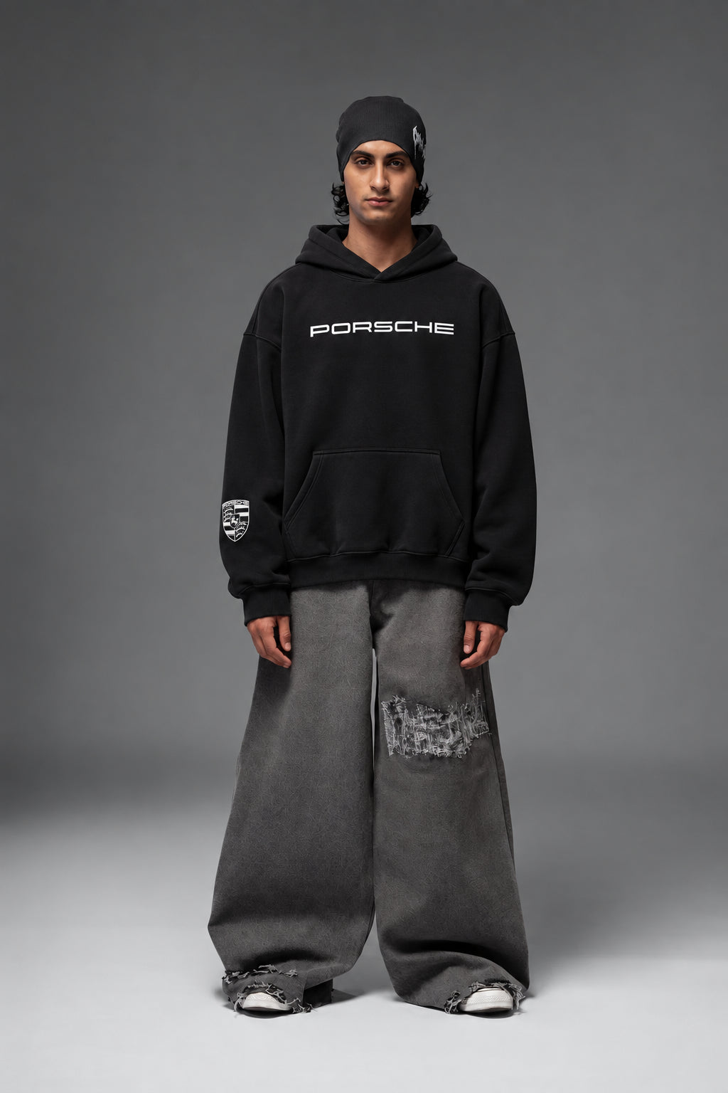 Full-length front view of the black Porsche oversized hoodie