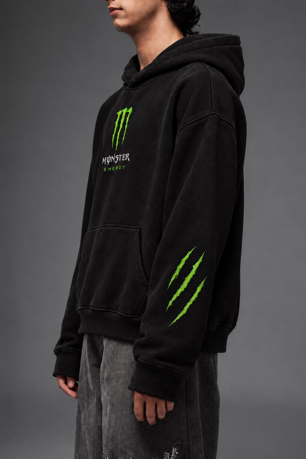 AMARCO MONSTER black oversized hoodie side view showing green sleeve graphics