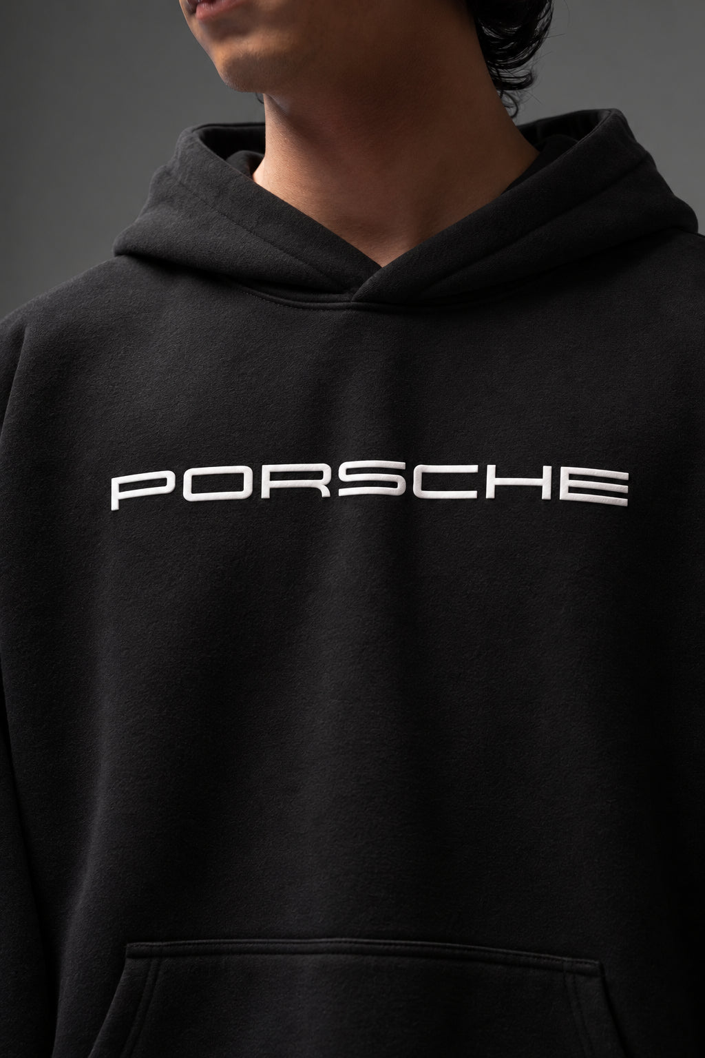Close-up of the white PORSCHE chest print