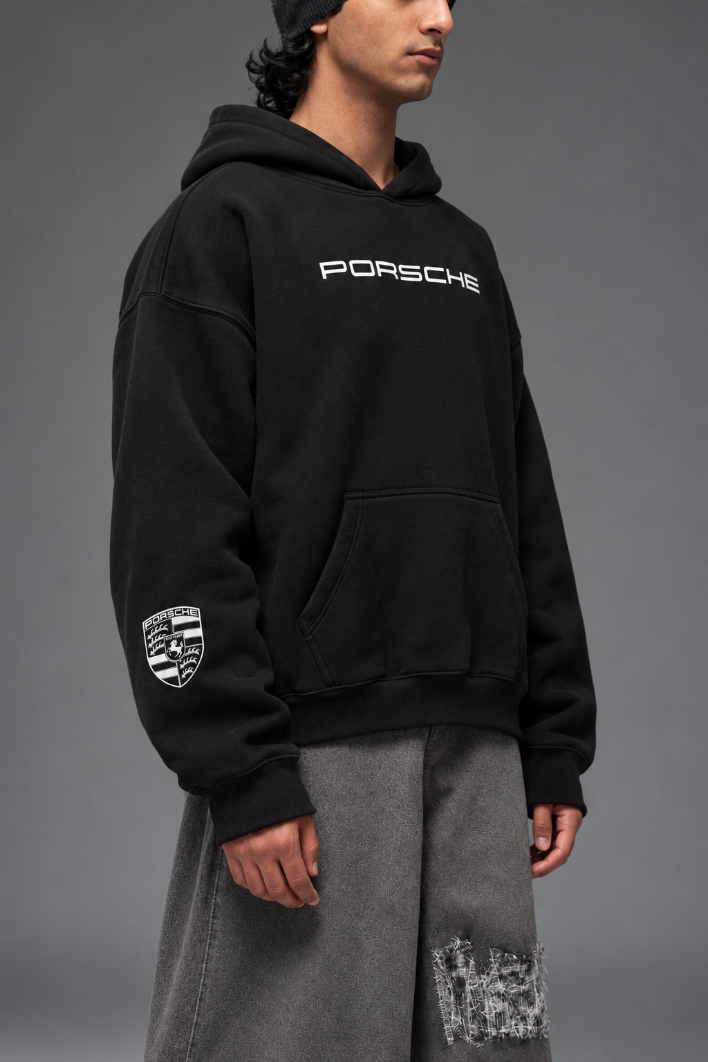 Close-up of the white Porsche crest on the sleeve