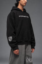 Close-up of the white Porsche crest on the sleeve