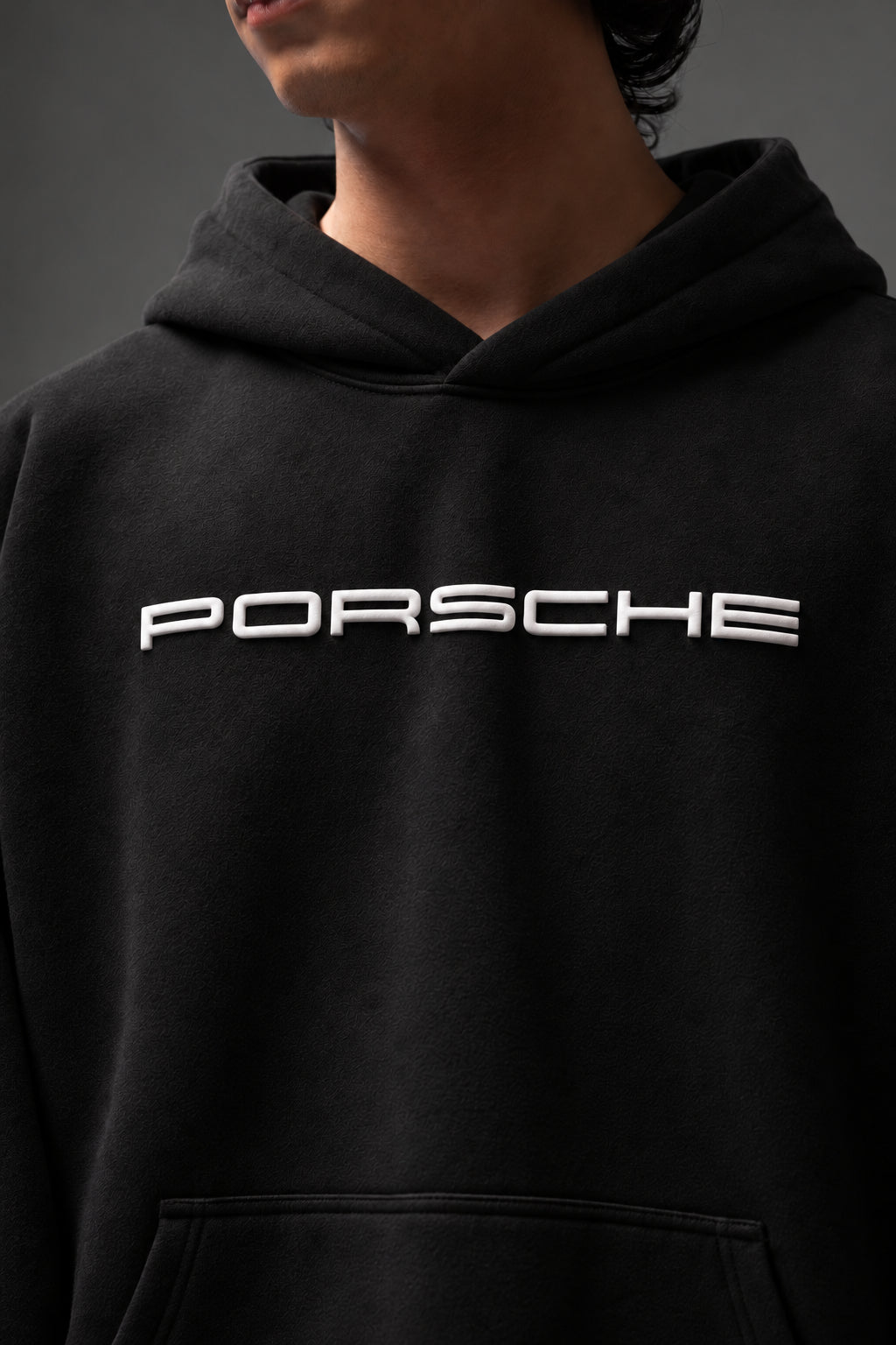 Close-up of the raised white PORSCHE chest lettering