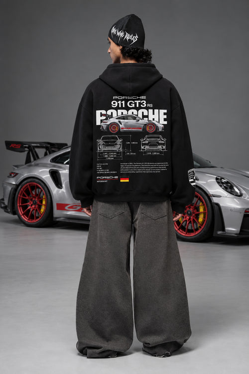 Full back view of the Porsche 911 GT3 RS hoodie beside a Porsche car