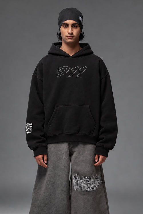 Front portrait of the black Porsche 911 oversized hoodie with outlined 911 chest graphic