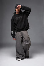 Front view of the Porsche 911 hoodie with the model posing