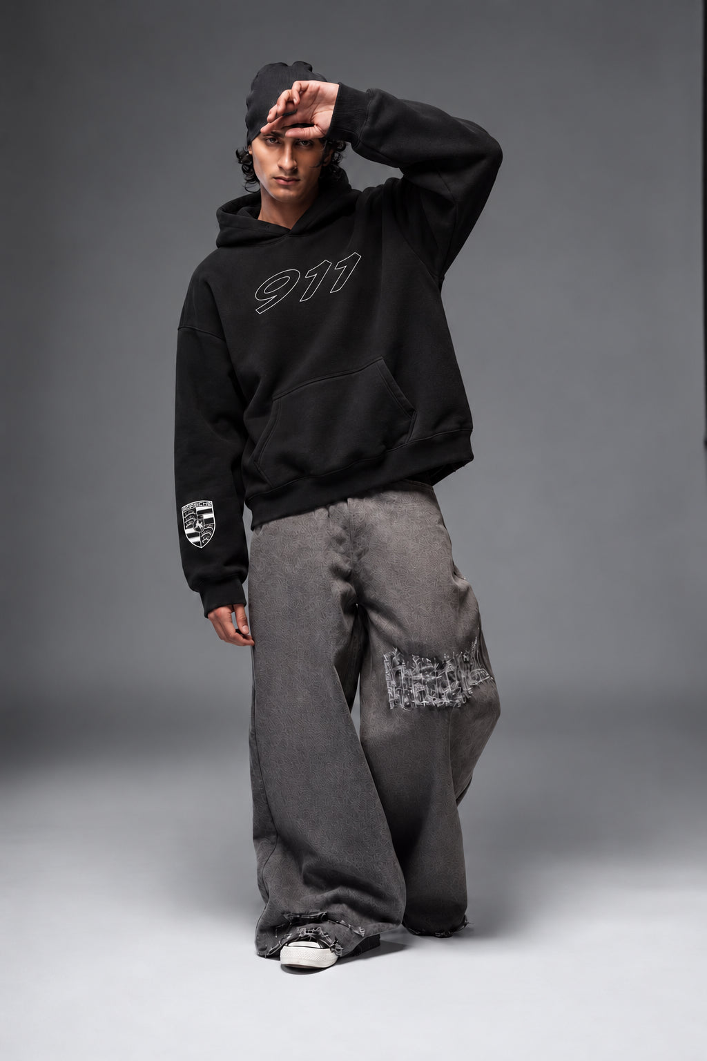 Front view of the Porsche 911 hoodie with the model posing