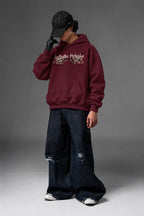 Infinite Petals oversized hoodie in Burgundy – angled front view